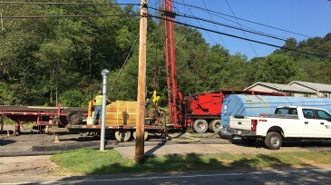Well plugging operation. Streetview with tanker, trailers, personnel