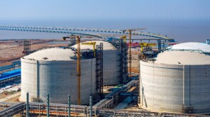 Many neatly arranged large cylindrical storage tanks
