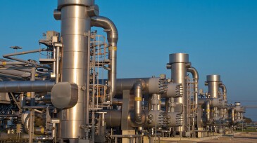 A modern natural gas processing plant during sunset