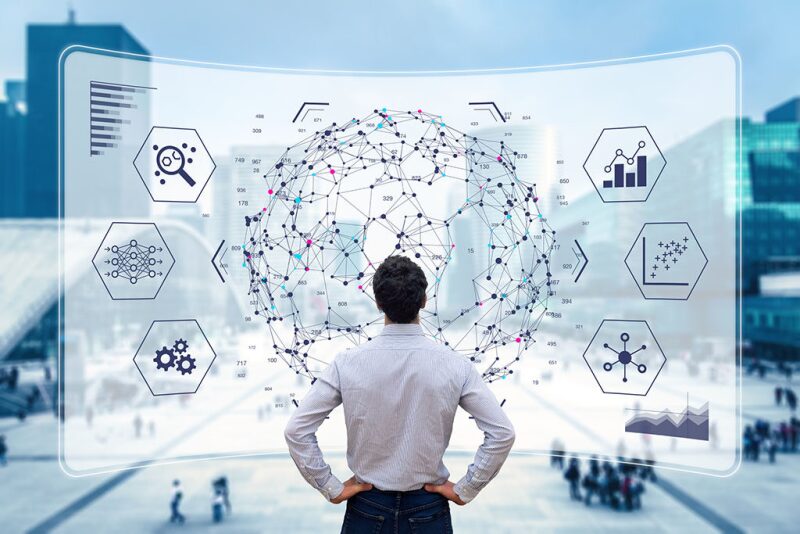 Man looking at globe with interconnected points and icons for various aspects of data and digital