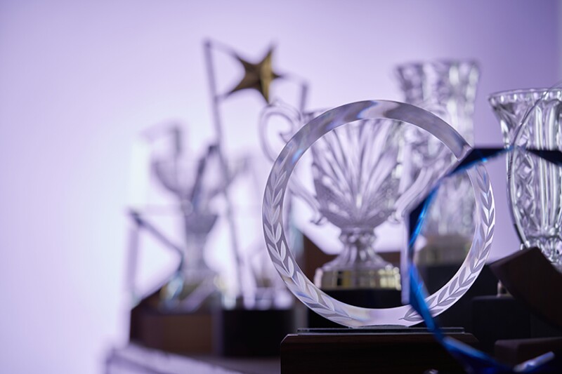 group of  crystal trophies against purple background