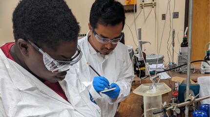 Tchemongo Berte (left) is studying low-salinity waterflooding assisted by a fellow University of Oklahoma grad student, Nayem Ahmed, whose research supports alternative energy.