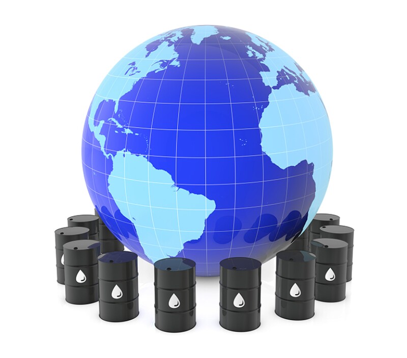 The globe of the earth and oil barrels