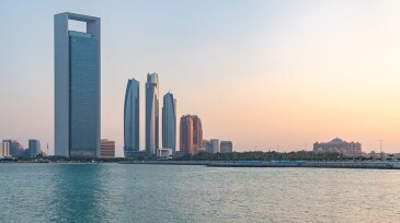 On the left, the Abu Dhabi National Oil Company (ADNOC) headquarters towers over the Abu Dhabi coast. Between 60 and 190 km offshore, the Ghasha concession is the site of a recent breakthrough, where hydraulic fracturing has unlocked a reservoir rock that stymied engineers for decades. Source: Bruno Coelhopt/Getty Images.