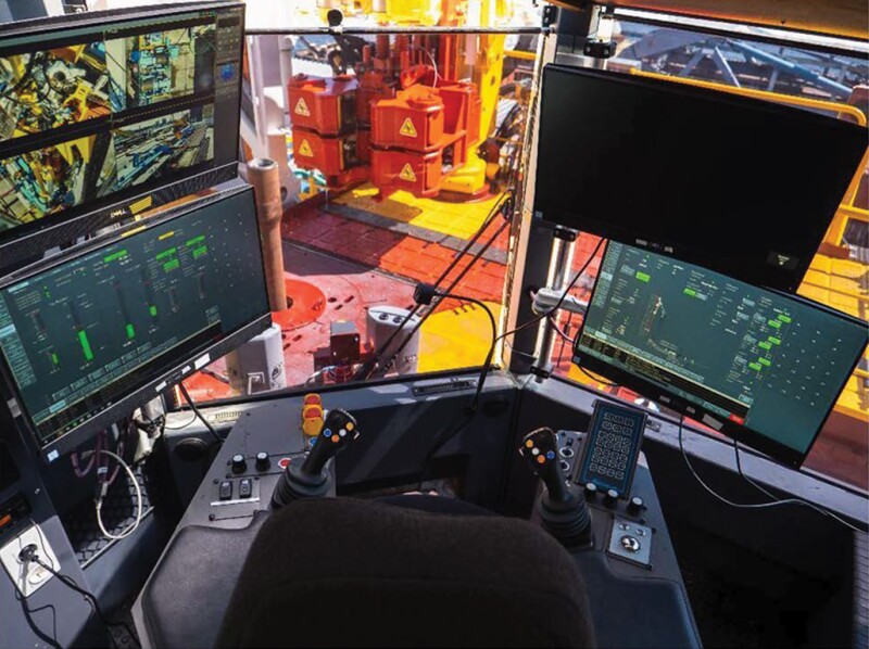 The view of the drilling floor and control panel in the driller’s cabin of a Huisman rig. 