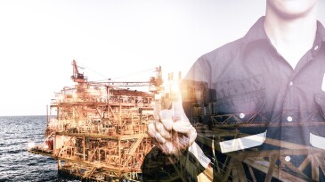 Double exposure of Engineer or Technician man pointing his finger for industry 4.0 concept with offshore oil and gas platform background for industrial business concept.