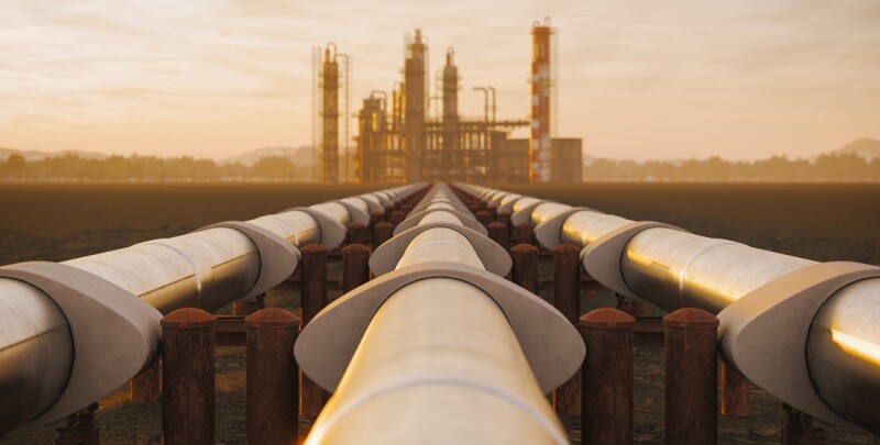 Oil Refinery And Pipeline In Desert During Sunset