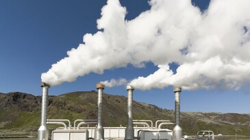 4 steel chimneys with smoke from geothermal energy