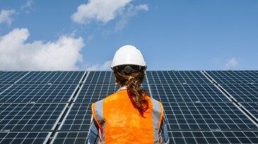 Solar Power Professional: Rear View of a Young Female Engineer at Sun Power Station