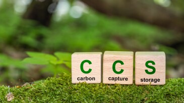 Symbol CCS  for Carbon Capture Storage words CCS on a wood cube on the environmental background. Net zero action concept. green energy, reduce carbon footprint, Save energy, carbon dioxide.