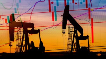 Illustration depicting the historic fall in the price of oil with an oil well in silhouette in the background