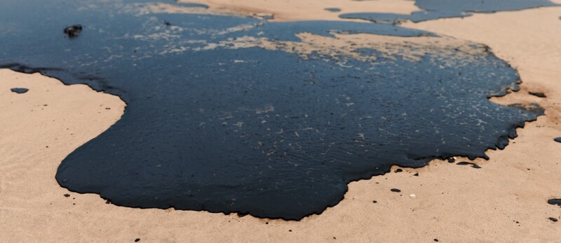 Fuel oil on sea coastline after a tanker wreck. Oil polluted beach