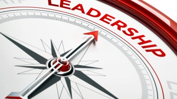 Arrow of a compass is pointing leadership text on the compass