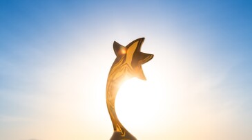 Gold star on a clear sky background as a reward