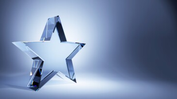 Crystal glass star trophy on a gradient blue background. 3D Rendering