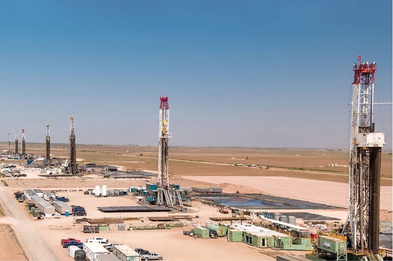 A row of drilling rigs help form what is known as a cube development in the Permian Basin. 