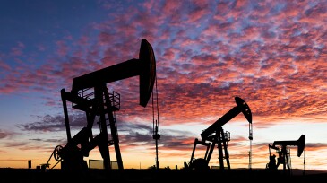Working oil pumps against a sunset sky.