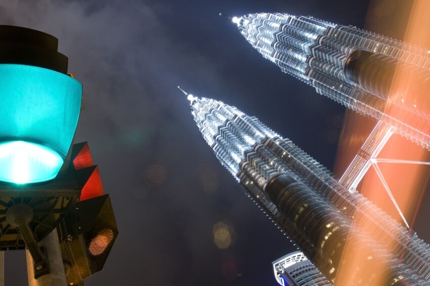 Kuala Lumpur at night with green light and Petronas Towers