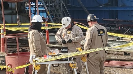 Engineers from Neubrex and SageRider connect fiber-optic cables for downhole monitoring.