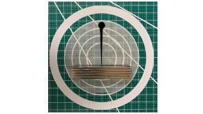 Fig. 1—Ferrofluid drop (black) attracted to magnets (gray) 50 mm away.