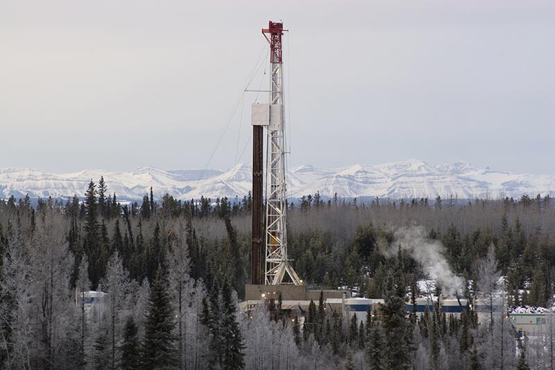 Drilling rig in foothills of the Rocky Mountains in Canada