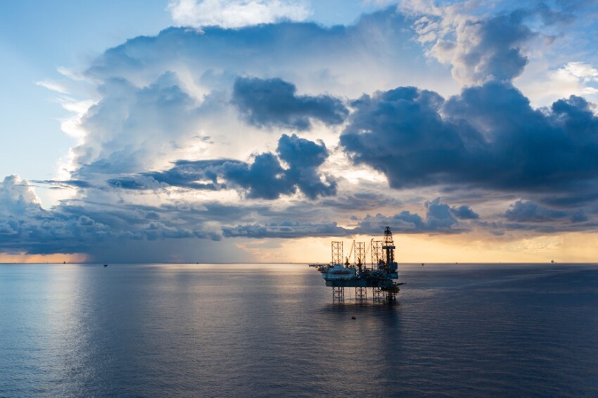 Offshore jack up rig in aerial view in the middle of the ocean taken by a drone