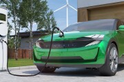 electric car SUV charging at home in front of modern low energy suburban house