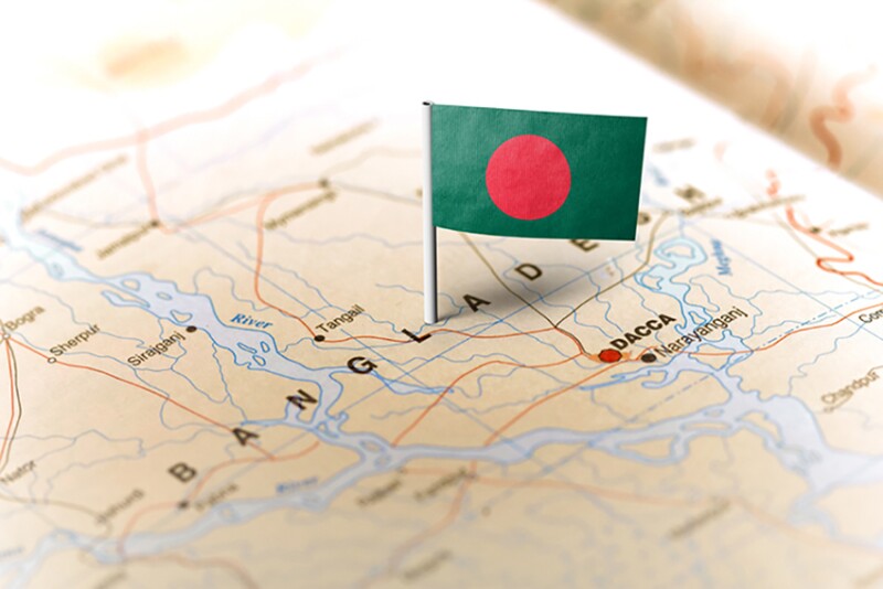 The flag of Bangladesh pinned on the map. Horizontal orientation. Macro photography.