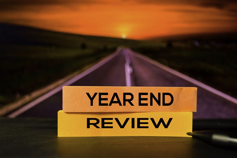 Year End Review on the sticky notes with bokeh background