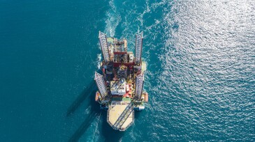 Oil rig on offshore area stock photo. Aerial view offshore jack up rig being towed to the location