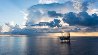 Offshore jack up rig in aerial view in the middle of the ocean taken by a drone