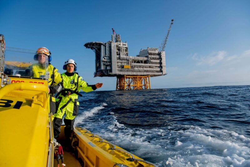 Workers on supply vessel leaving platform