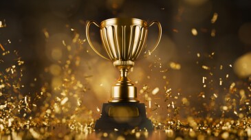 Winner's Cup, symbolizing victory and success in competitions. First place prize. Trophy for winning in business. The winner's shiny gold cup symbolizes victory and success in competition.