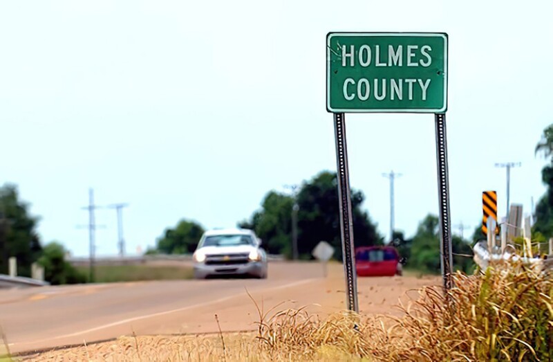 Holmes County sign on road