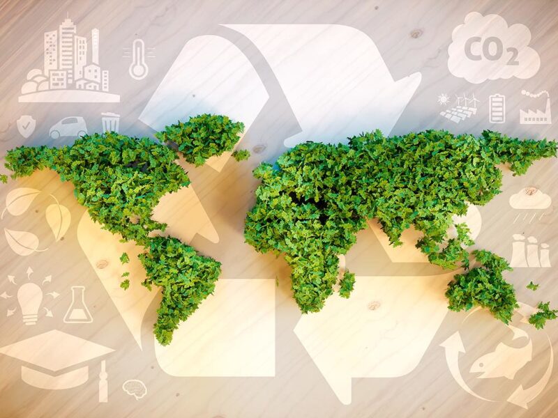 Continents filled with greenery overlaid on symbols representing recycling, education, CO2, industrialization