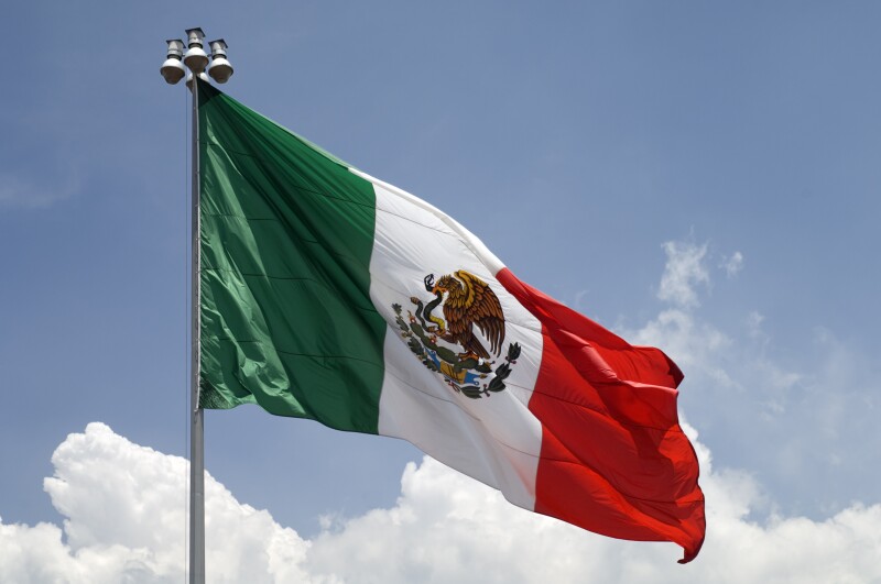 Flag of Mexico with blue sky