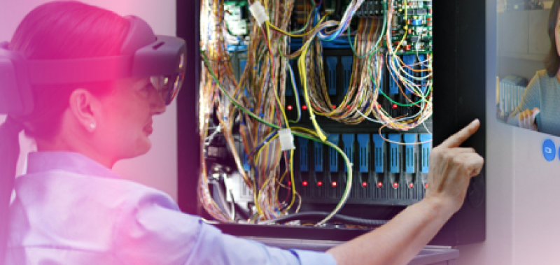 Female worker with AR goggles examines a maintenance panel