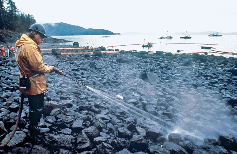 Workers steam-blast rocks covered in crude oil leaking from the Exxon Valdez, an oil tanker that ran aground in 1989 in Prince William Sound, Alaska.