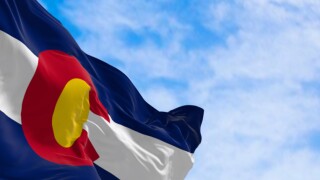 Close-up of Colorado state flag waving in the wind on a clear day