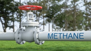 White Industrial Pipelines Transporting Methane Gas Across Green Field. Energy Infrastructure Concept