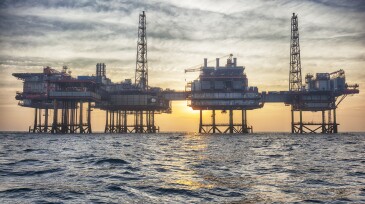 Offshore oil platform at sunset