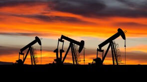 A new day dawns for a trio of pumpjacks at work.