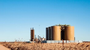 A tank battery in an oil field where oil and produced water are stored.