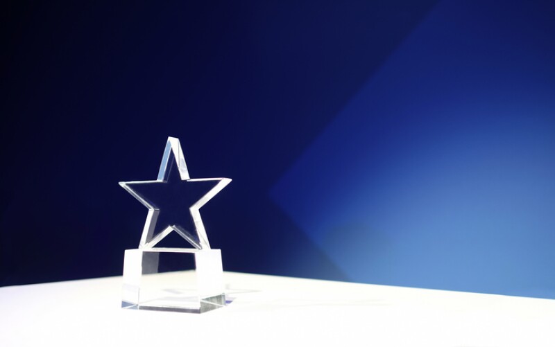 Award on a table with spotlights and copy space