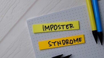 Imposter Syndrome text on sticky notes isolated on office desk