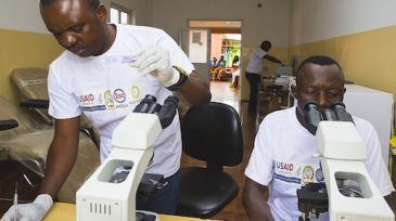 Researches use microscopes to study malaria.