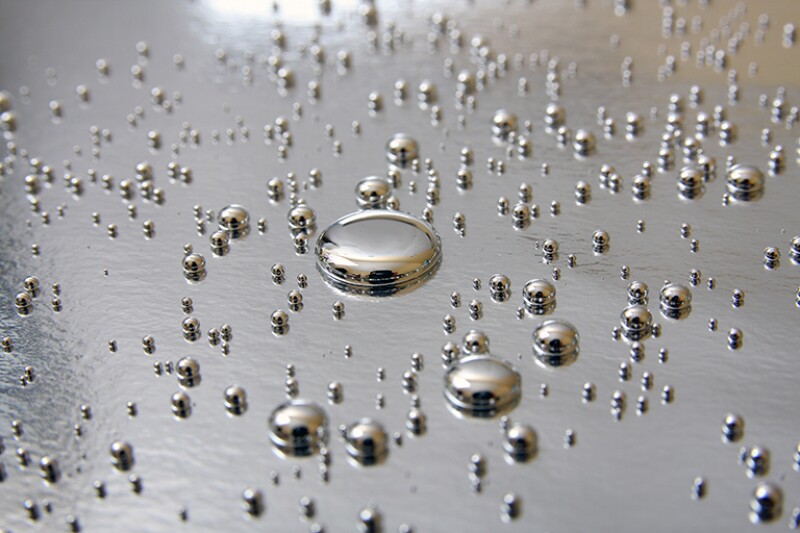 Mercury drops on silver background