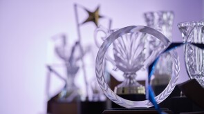 group of  crystal trophies against purple background