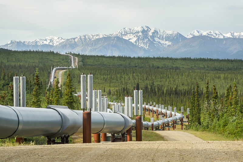 Pipeline winding in summer mountain landscape.
