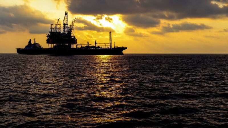 FPSO silhouetted against dramatic sky